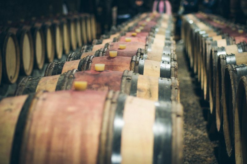 Wooden wine barrels aging in an Alsace winery cellar