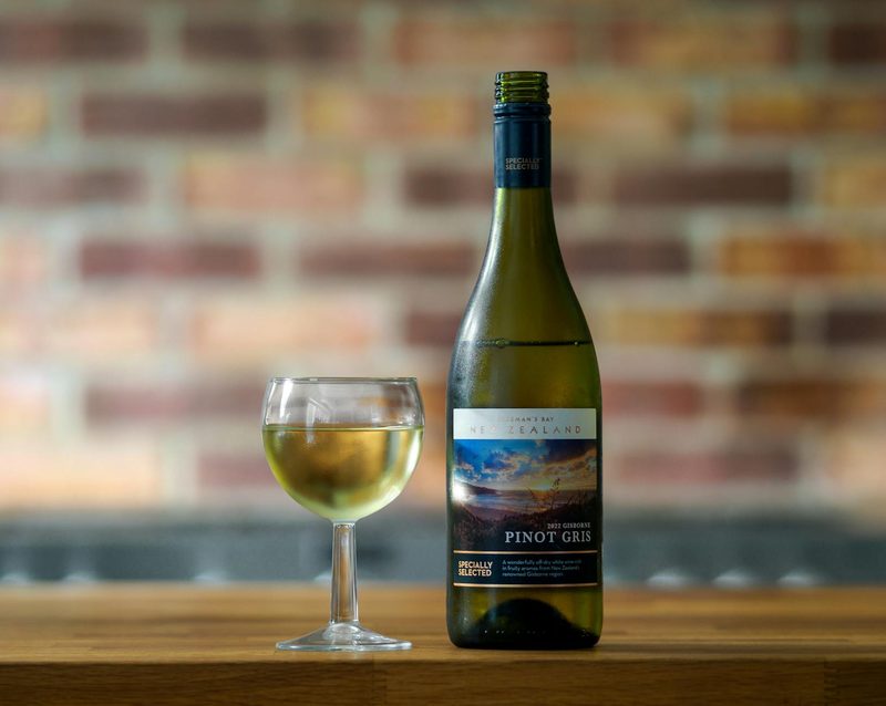 Bottle and glass of Pinot Gris white wine on a table