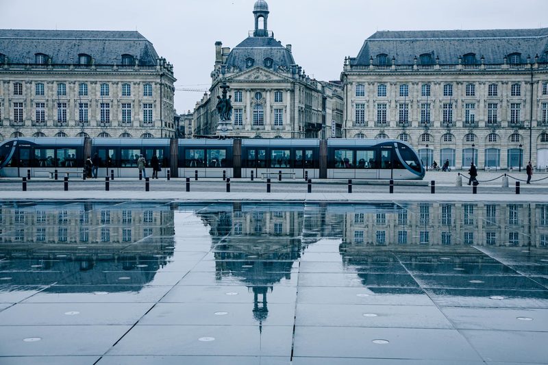 Bordeaux tram passing by the historic Place de la Bourse reflecting on the Miroir d eau