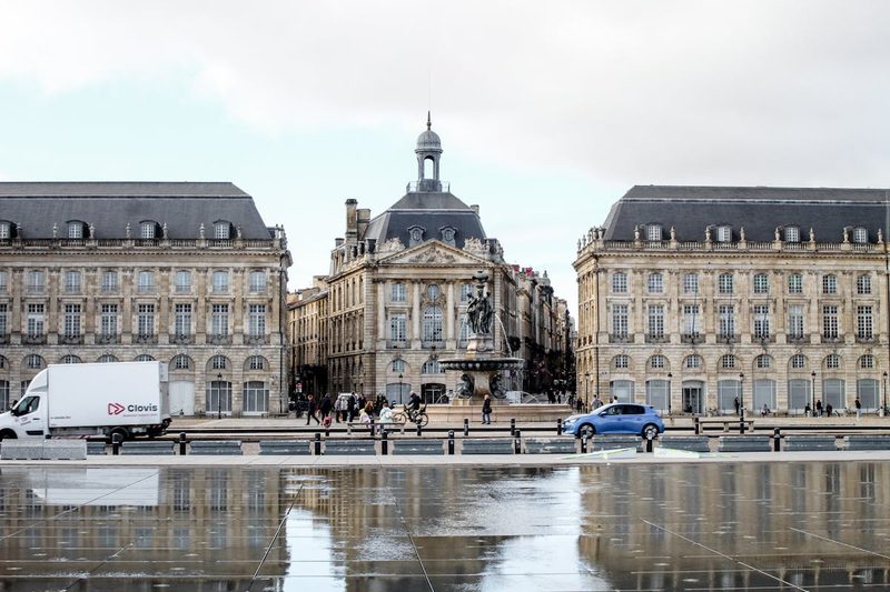 Place de la Bourse in Bordeaux, France with stunning reflection on wet pavement