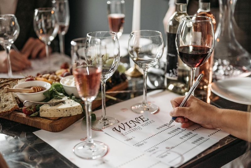 Wine tasting event with detailed tasting notes and cheese platter on the table