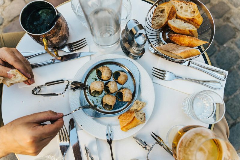 French escargot and baguette on a plate, a classic Burgundian dining experience