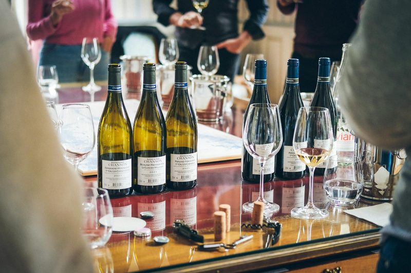 Wine tasting setup with bottles and glasses arranged on a table in Beaune, Burgundy