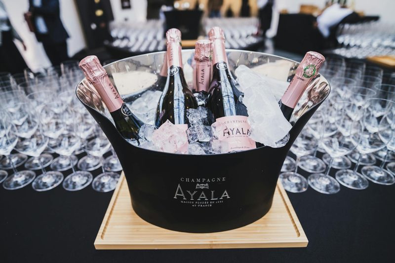 Elegant display of Ayala Champagne bottles chilling in an ice bucket, ready for tasting