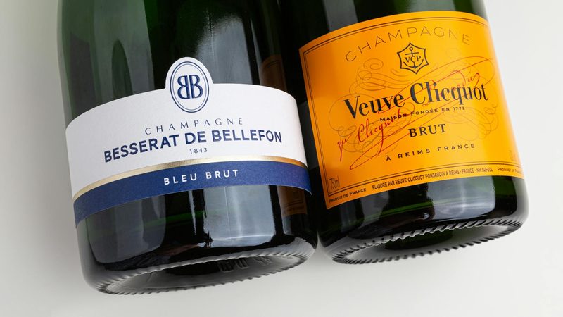Close-up of Veuve Clicquot and Besserat de Bellefon champagne bottles, two iconic Champagne house brands