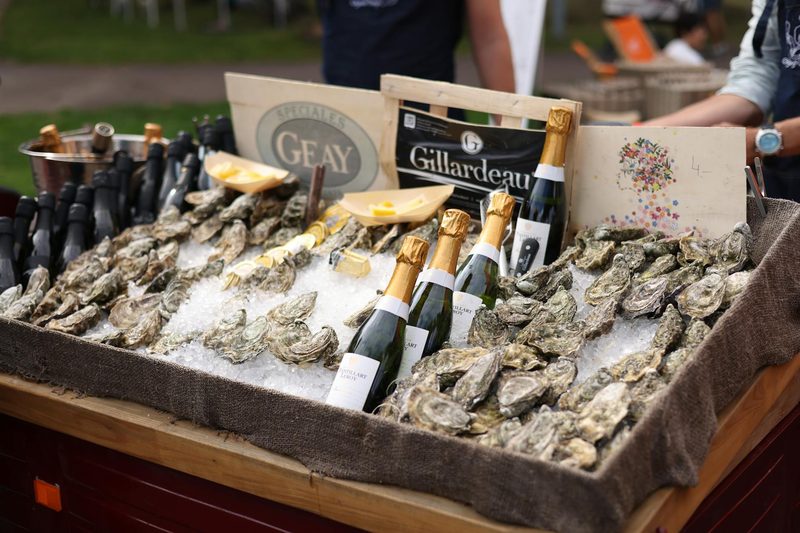 Elegant display of champagne bottles and fresh oysters on ice, a classic French food and champagne pairing
