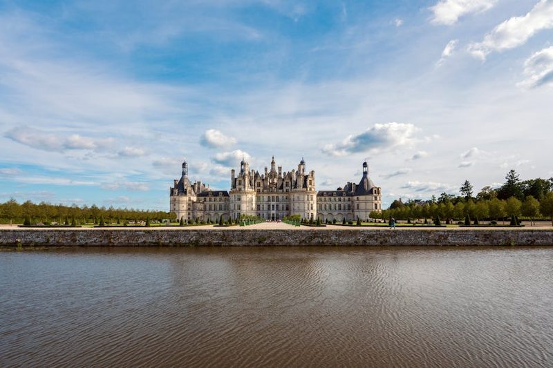 Chateau de Chambord with picturesque reflection on a sunny day