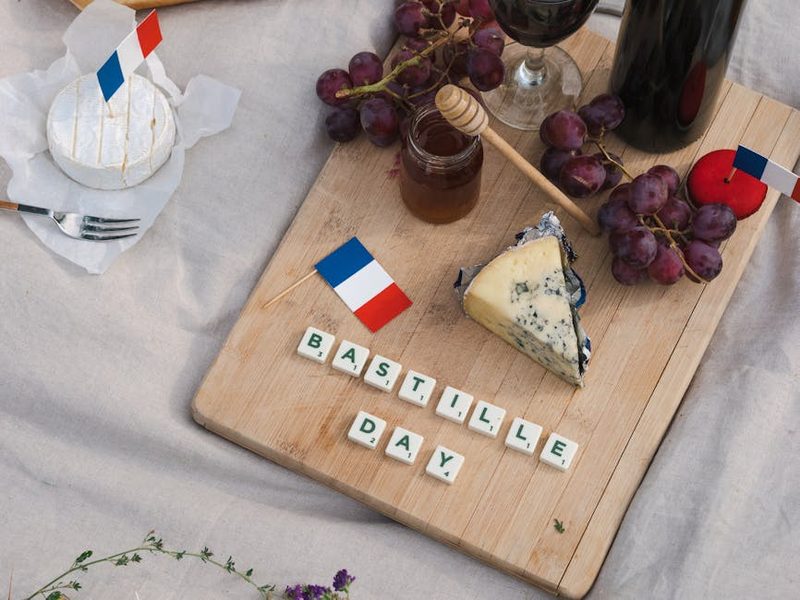 French picnic spread with cheese wine grapes and charcuterie
