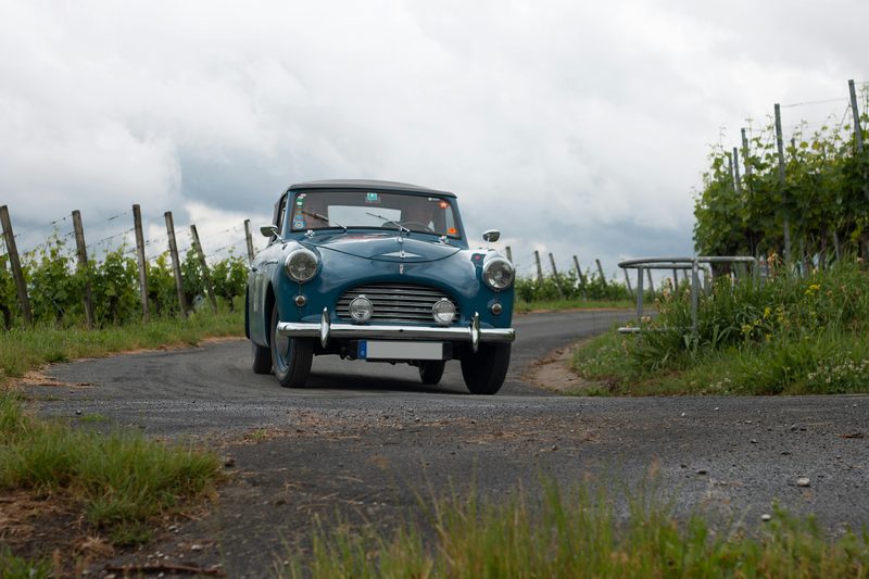 Car driving along a road through French vineyard countryside