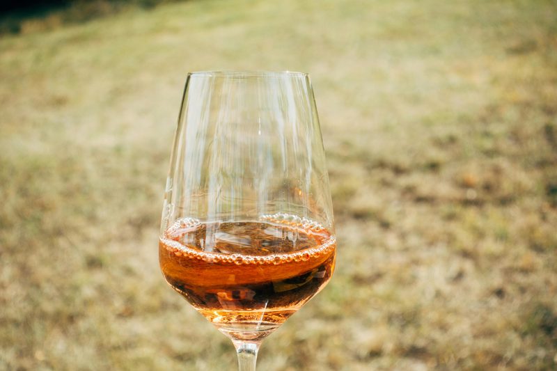 Glass of rosé wine in a warm summer setting
